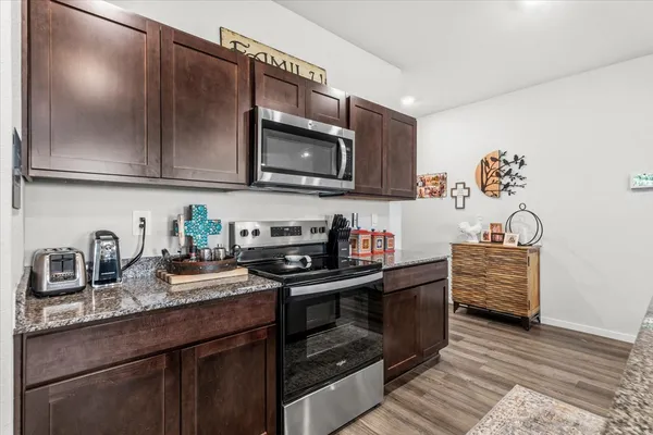 a kitchen with granite countertop a stove and a sink