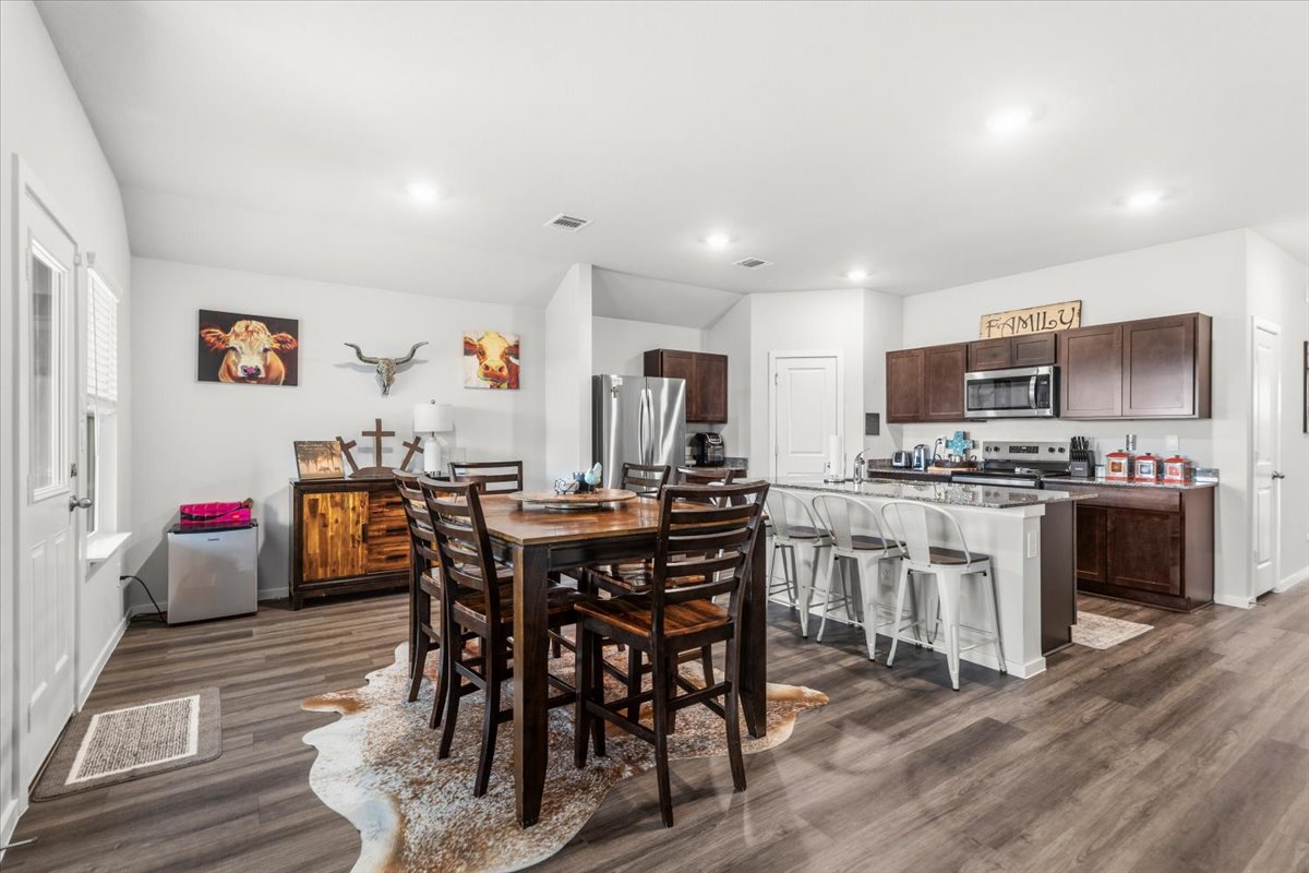 402 Perry Place Rockdale, TX 76567 - Photo 9 of 31 Dining space with dark wood finished floors and recessed lighting