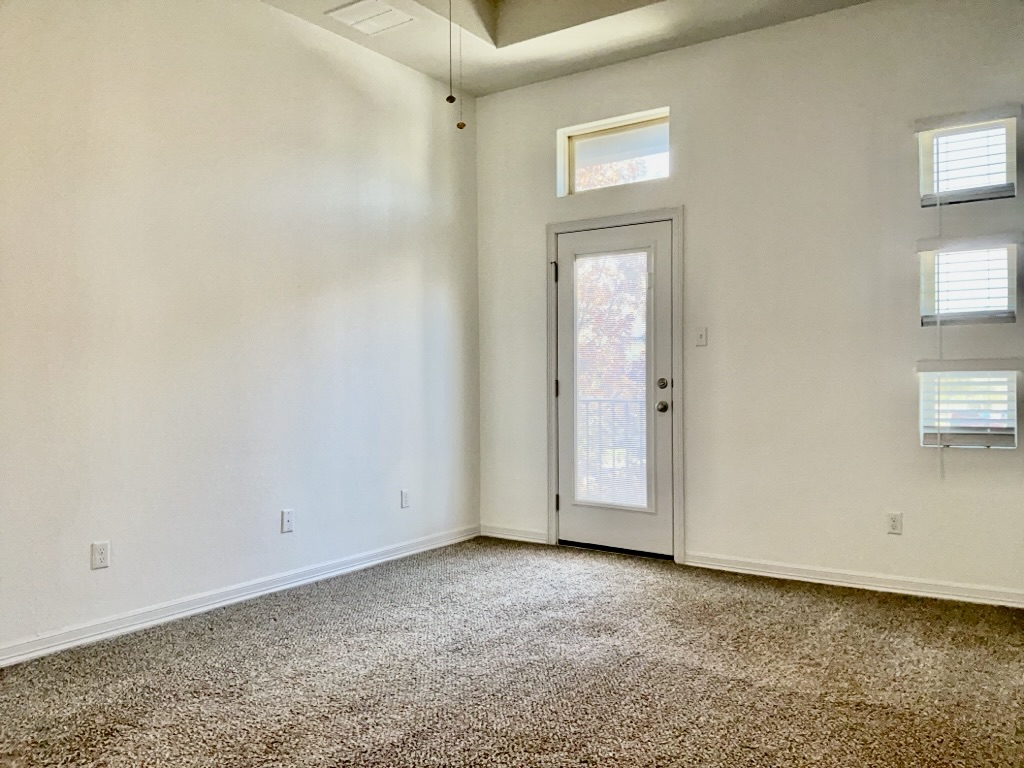 18005 Pomelo Lane, Unit A Pflugerville, TX 78660 - Photo 11 of 28 an empty room with windows