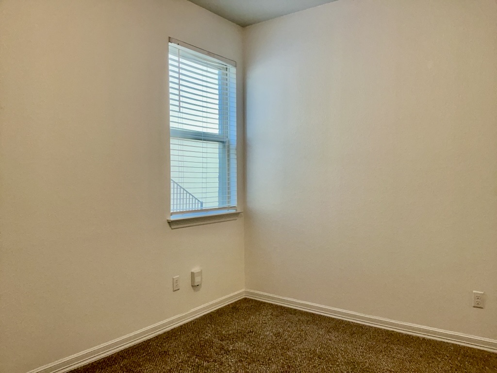 18005 Pomelo Lane, Unit A Pflugerville, TX 78660 - Photo 16 of 28 an empty room with a window