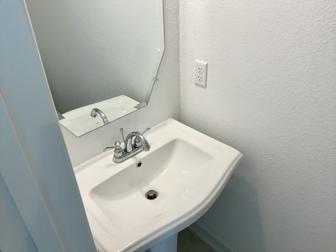 18005 Pomelo Lane, Unit A Pflugerville, TX 78660 - Photo 18 of 28 a bathroom with a sink and a toilet