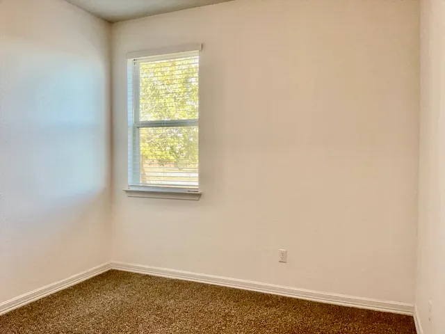 an empty room with closet area