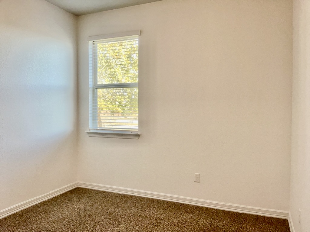 18005 Pomelo Lane, Unit A Pflugerville, TX 78660 - Photo 19 of 28 an empty room with a window