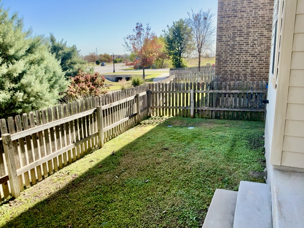 18005 Pomelo Lane, Unit A Pflugerville, TX 78660 - Photo 28 of 28 a view of a chair and table in the garden