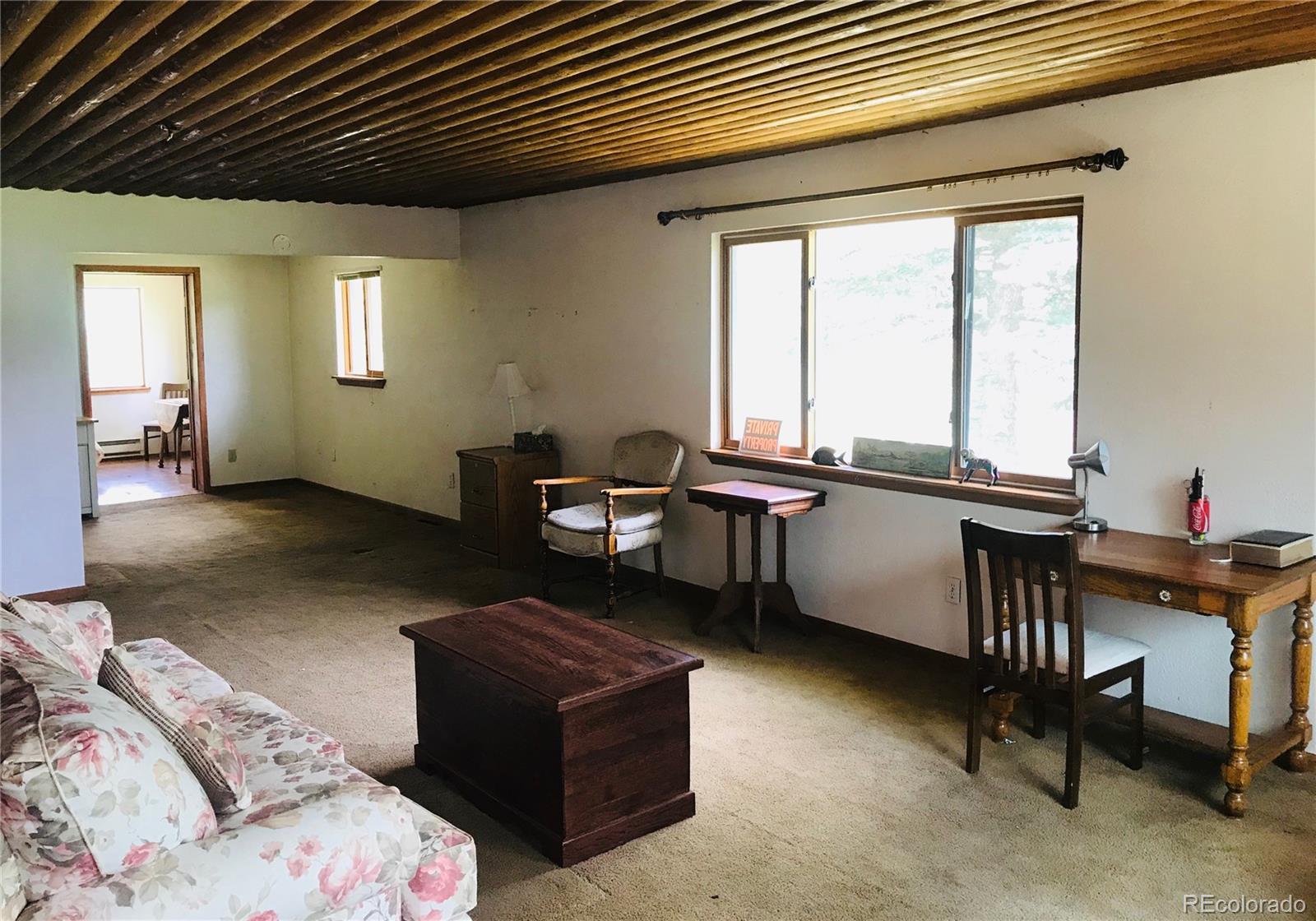 538 Neal Road Bailey, CO 80421 - Photo 12 of 20 a livingroom with workspace couch and a window