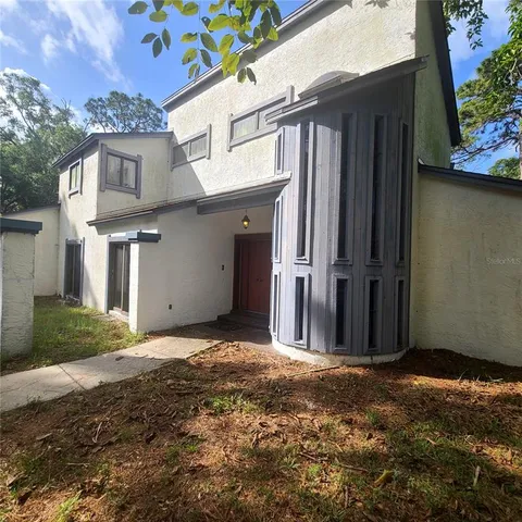 a view of a front door and small yard
