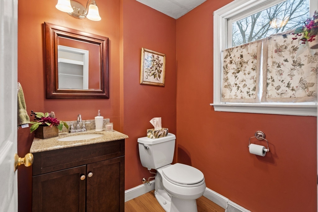 28 Coleman Road Groveland, MA 01834 - Photo 12 of 37 a bathroom with a toilet a sink a mirror and a window