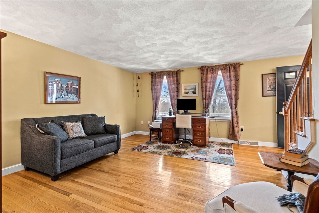 28 Coleman Road Groveland, MA 01834 - Photo 14 of 37 a living room with fireplace furniture and a flat screen tv