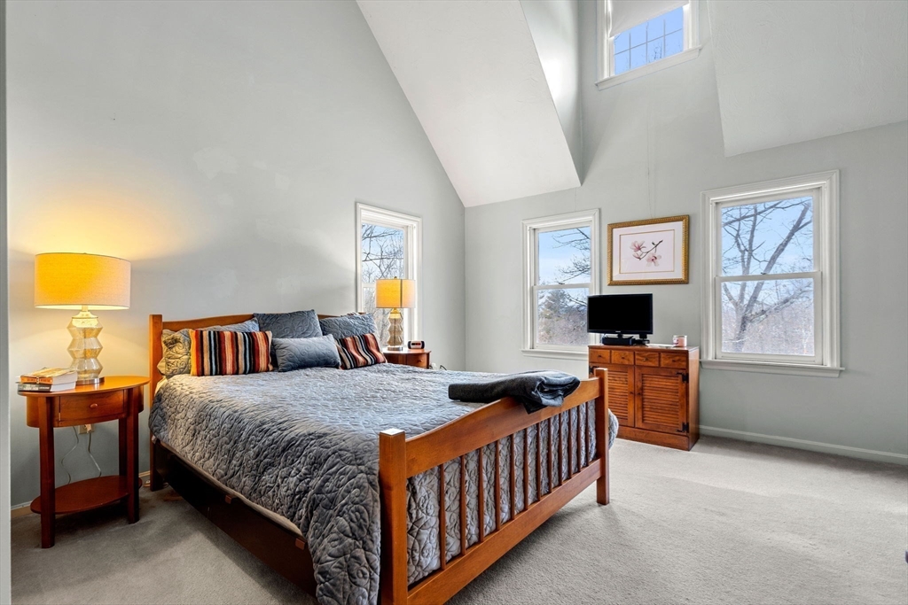 28 Coleman Road Groveland, MA 01834 - Photo 19 of 37 a bedroom with a bed and a flat screen tv