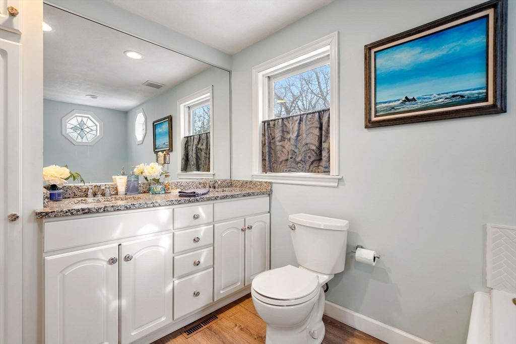 28 Coleman Road Groveland, MA 01834 - Photo 21 of 37 a bathroom with a granite countertop toilet sink and mirror