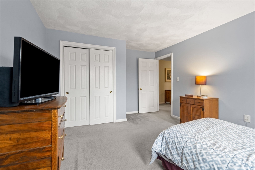 28 Coleman Road Groveland, MA 01834 - Photo 27 of 37 a bedroom with a bed and a flat screen tv