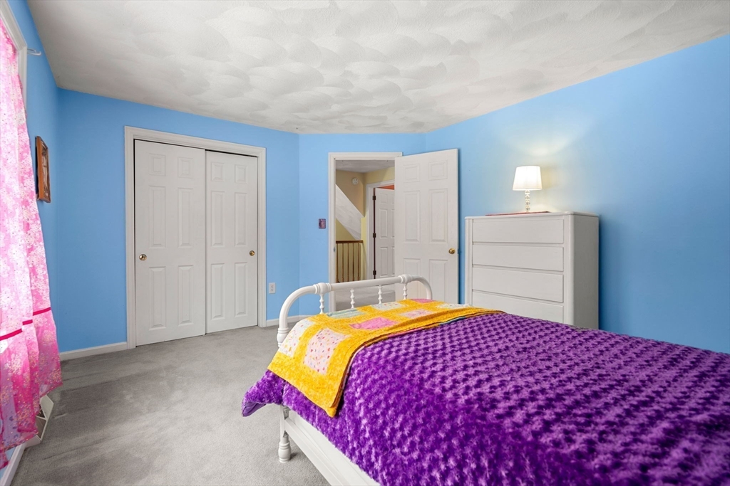 28 Coleman Road Groveland, MA 01834 - Photo 29 of 37 a bedroom with a bed and a mirror