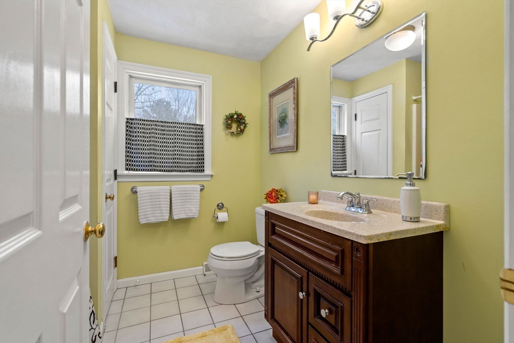 28 Coleman Road Groveland, MA 01834 - Photo 32 of 37 a bathroom with a sink a toilet and mirror
