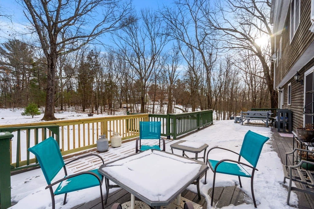 28 Coleman Road Groveland, MA 01834 - Photo 35 of 37 a view of a patio with a table chairs and a fire pit