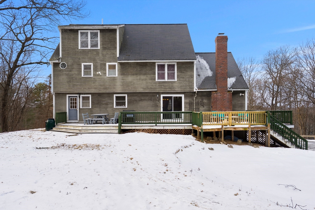 28 Coleman Road Groveland, MA 01834 - Photo 37 of 37 a front view of a house with a yard covered in snow