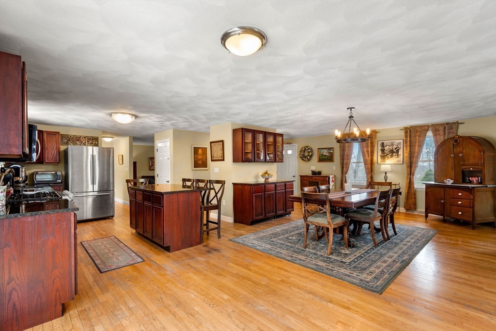 28 Coleman Road Groveland, MA 01834 - Photo 5 of 37 a living room with furniture a dining table and chairs