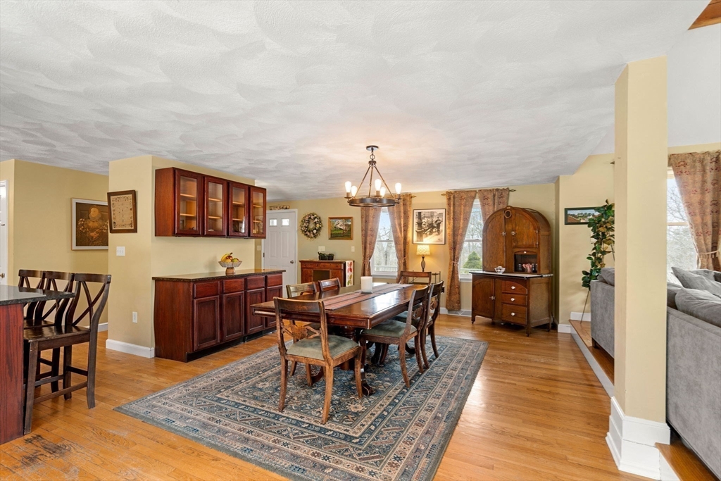 28 Coleman Road Groveland, MA 01834 - Photo 8 of 37 a living room with furniture a dining table and kitchen view