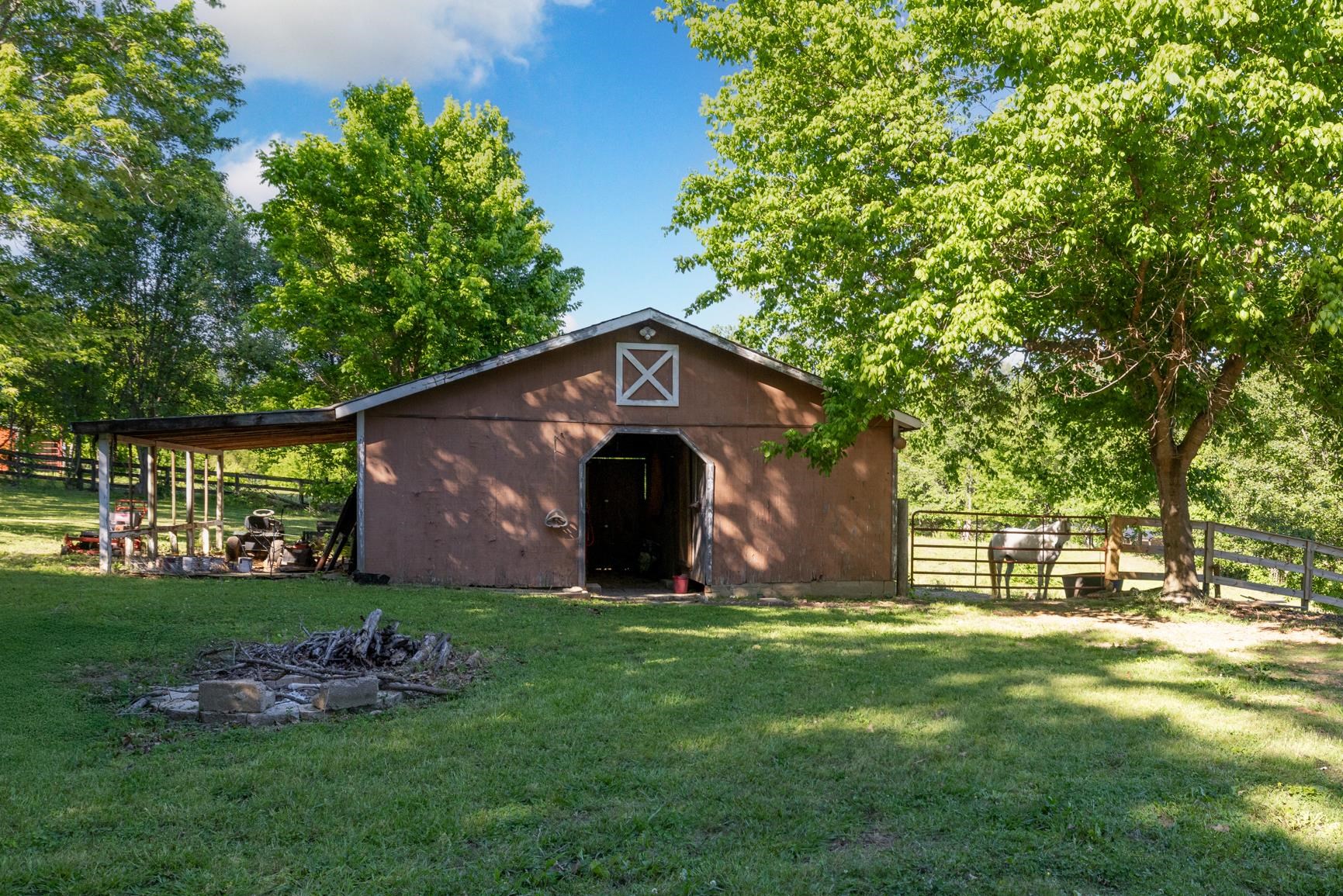 366 Adkins Road Burlison, TN 38015 - Photo 17 of 20 Barn structure featuring a shed roof extension, a main entrance, and an upper gable vent