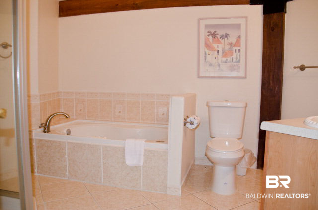 5751 Alabama Street Orange Beach, AL 36561 - Photo 16 of 25 The Master Bath features a Jacuzzi tub and double vanity plus a separate shower.