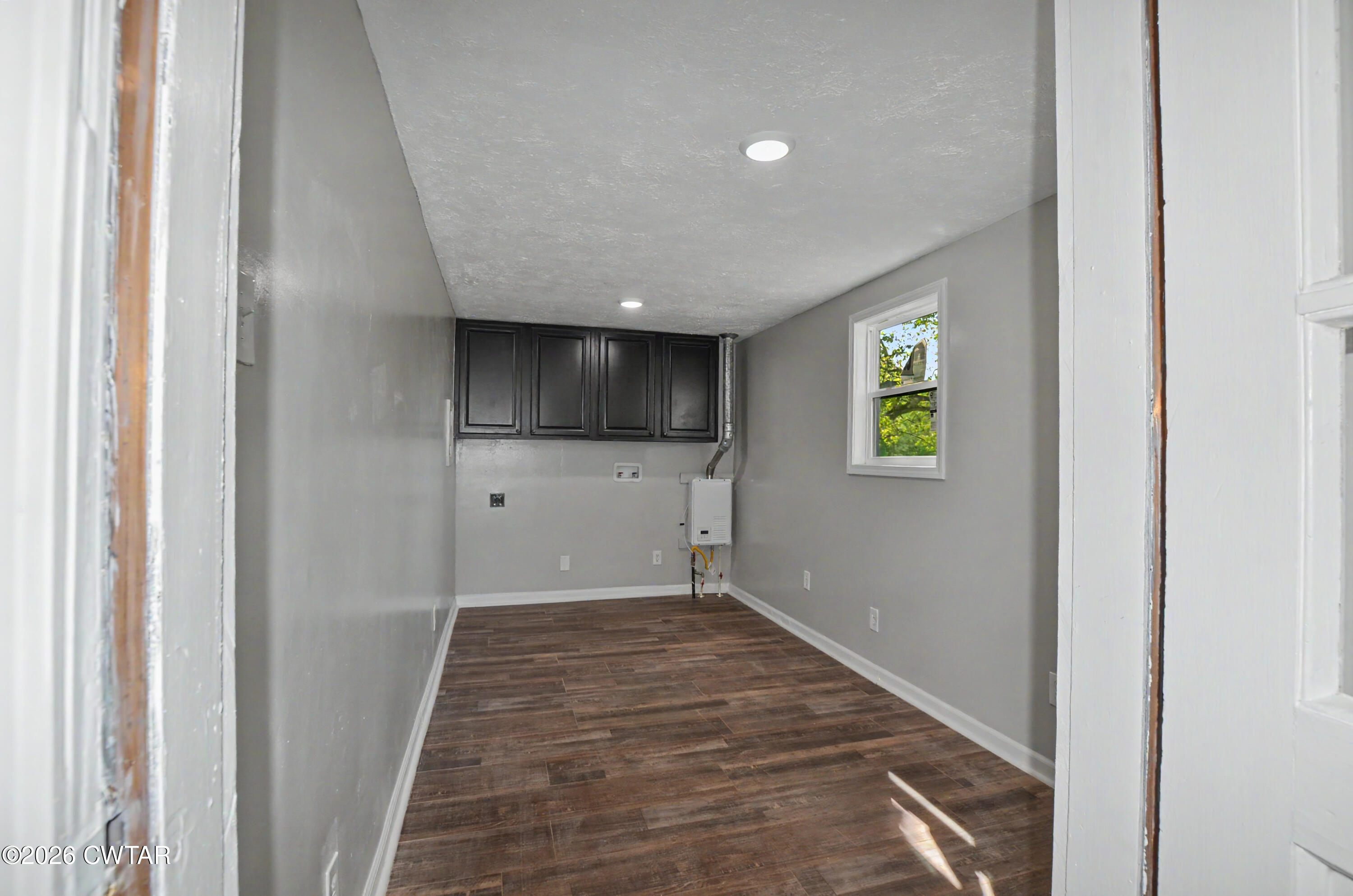 4177 Gum Flat Road Bells, TN 38006 - Photo 19 of 30 a view of a hallway with wooden floor and a refrigerator
