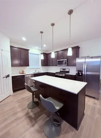 a large bedroom with furniture and a wooden floor
