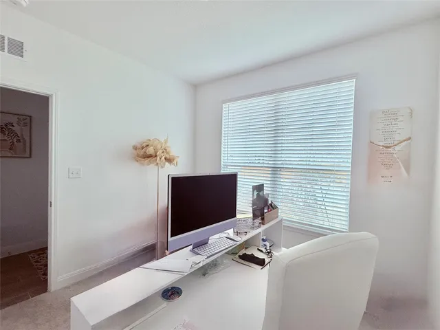 a view of a workspace with furniture