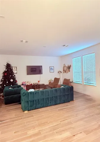 a kitchen with kitchen island stainless steel appliances a table chairs sink refrigerator and microwave