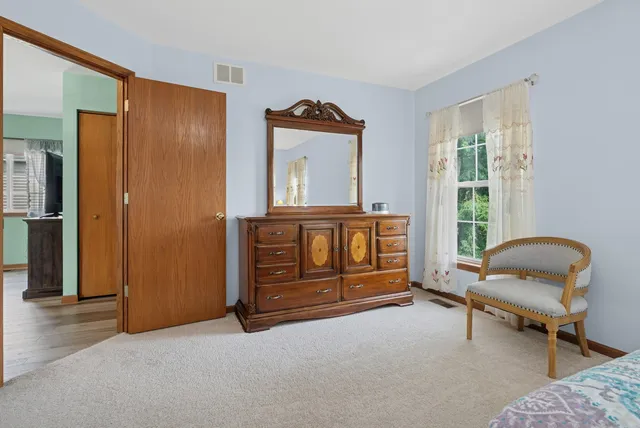 a bedroom with furniture and a window