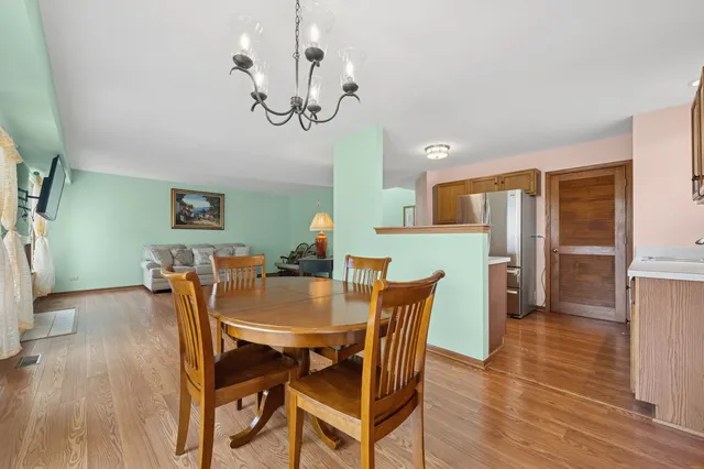 a view of a dining room with furniture and wooden floor