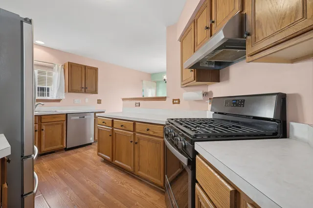a kitchen with a stove sink and cabinets