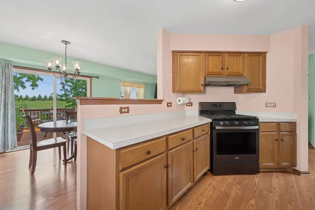 a kitchen with a stove a sink and a dining table