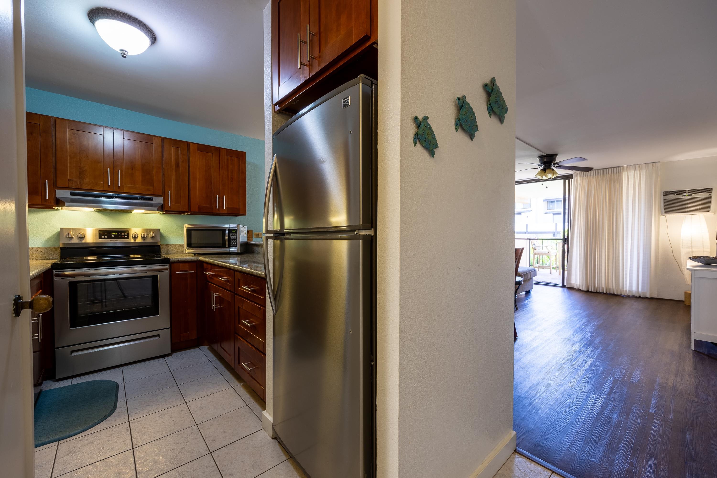2695 South Kihei Road, Unit 9209 Kihei, HI 96753 - Photo 13 of 50 a kitchen with a refrigerator and a stove top oven
