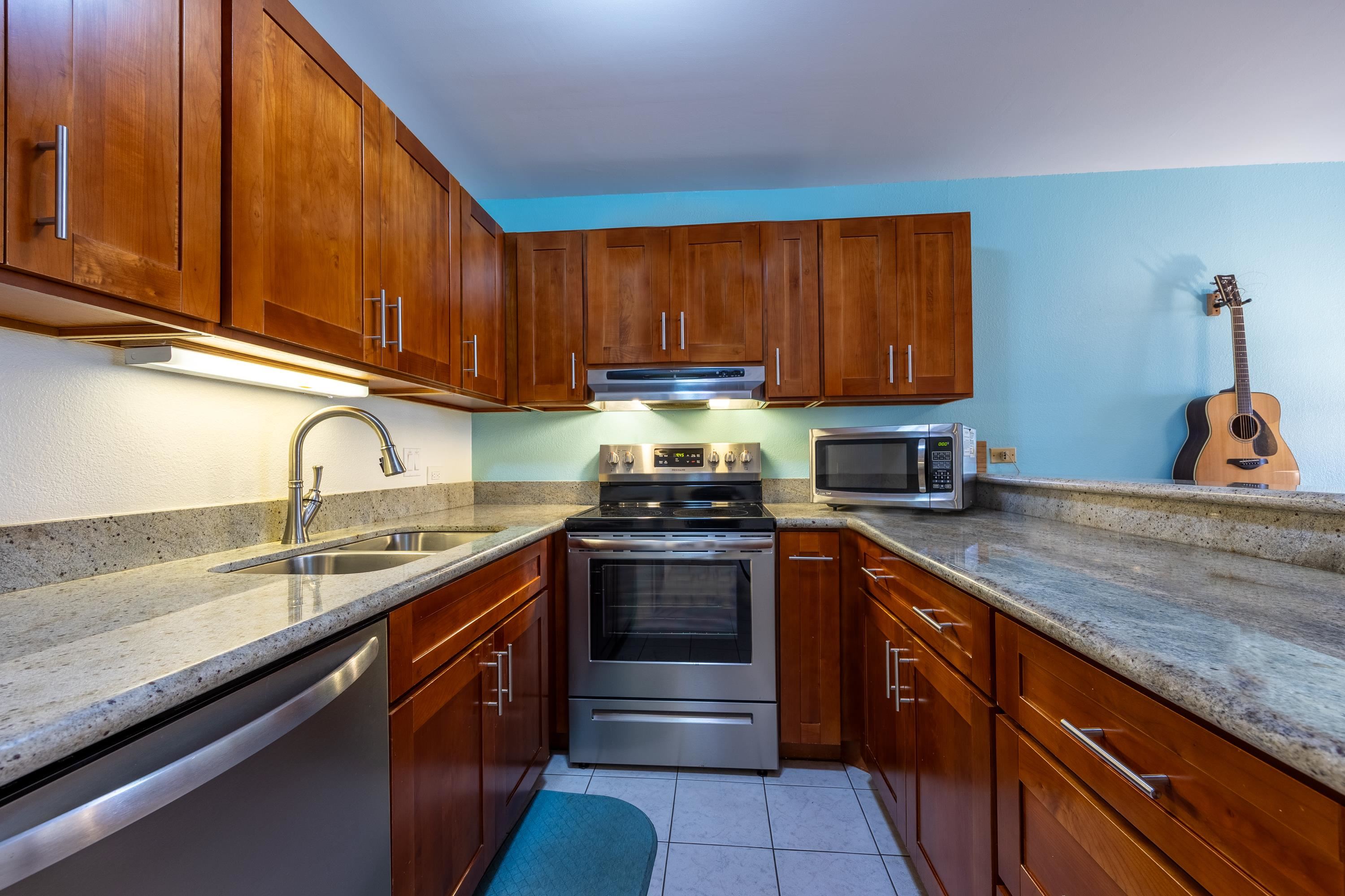 2695 South Kihei Road, Unit 9209 Kihei, HI 96753 - Photo 14 of 50 a kitchen with stainless steel appliances granite countertop a sink stove and cabinets