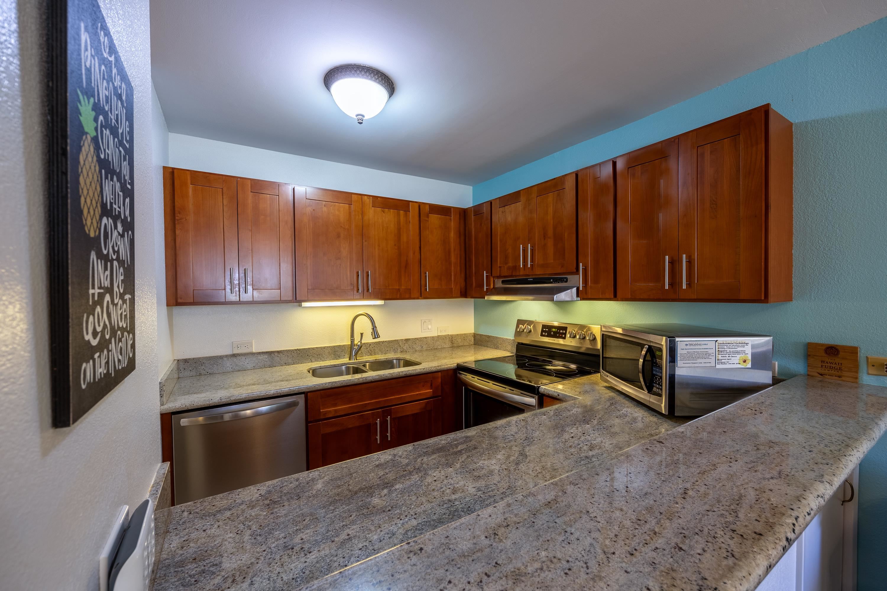 2695 South Kihei Road, Unit 9209 Kihei, HI 96753 - Photo 15 of 50 a kitchen with stainless steel appliances granite countertop a stove a sink and a microwave