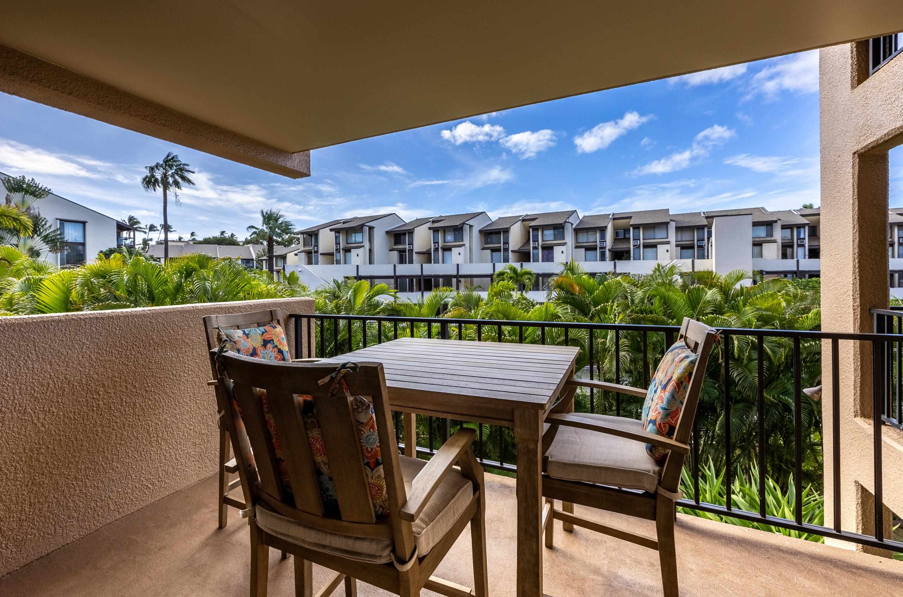2695 South Kihei Road, Unit 9209 Kihei, HI 96753 - Photo 27 of 50 a view of a chairs and table in patio with a yard