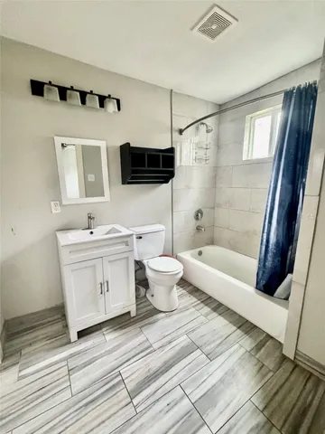 a bathroom with a double vanity sink mirror and shower