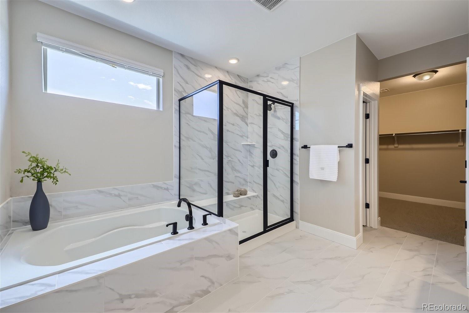 12864 Pinnacle Firestone, CO 80504 - Photo 13 of 29 a spacious bathroom with a tub and shower