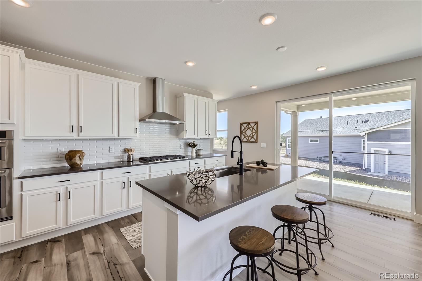 12864 Pinnacle Firestone, CO 80504 - Photo 2 of 29 a kitchen with a table and chairs in it