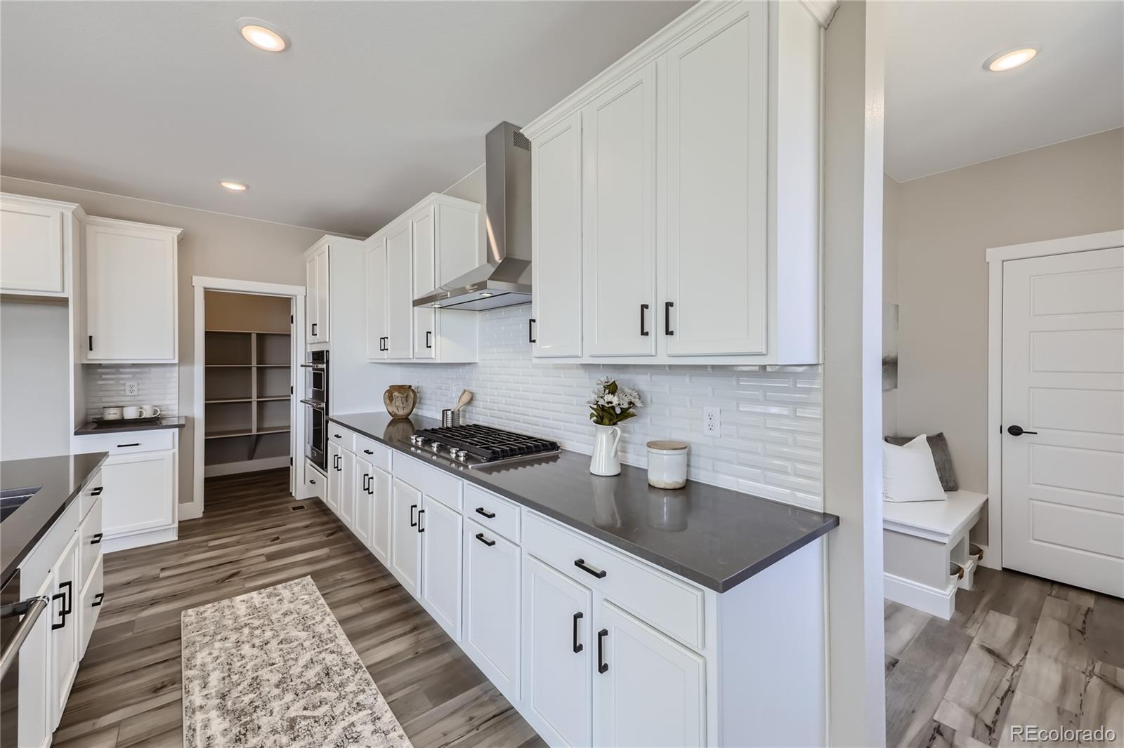 12864 Pinnacle Firestone, CO 80504 - Photo 3 of 29 a kitchen with granite countertop a sink stove and cabinets