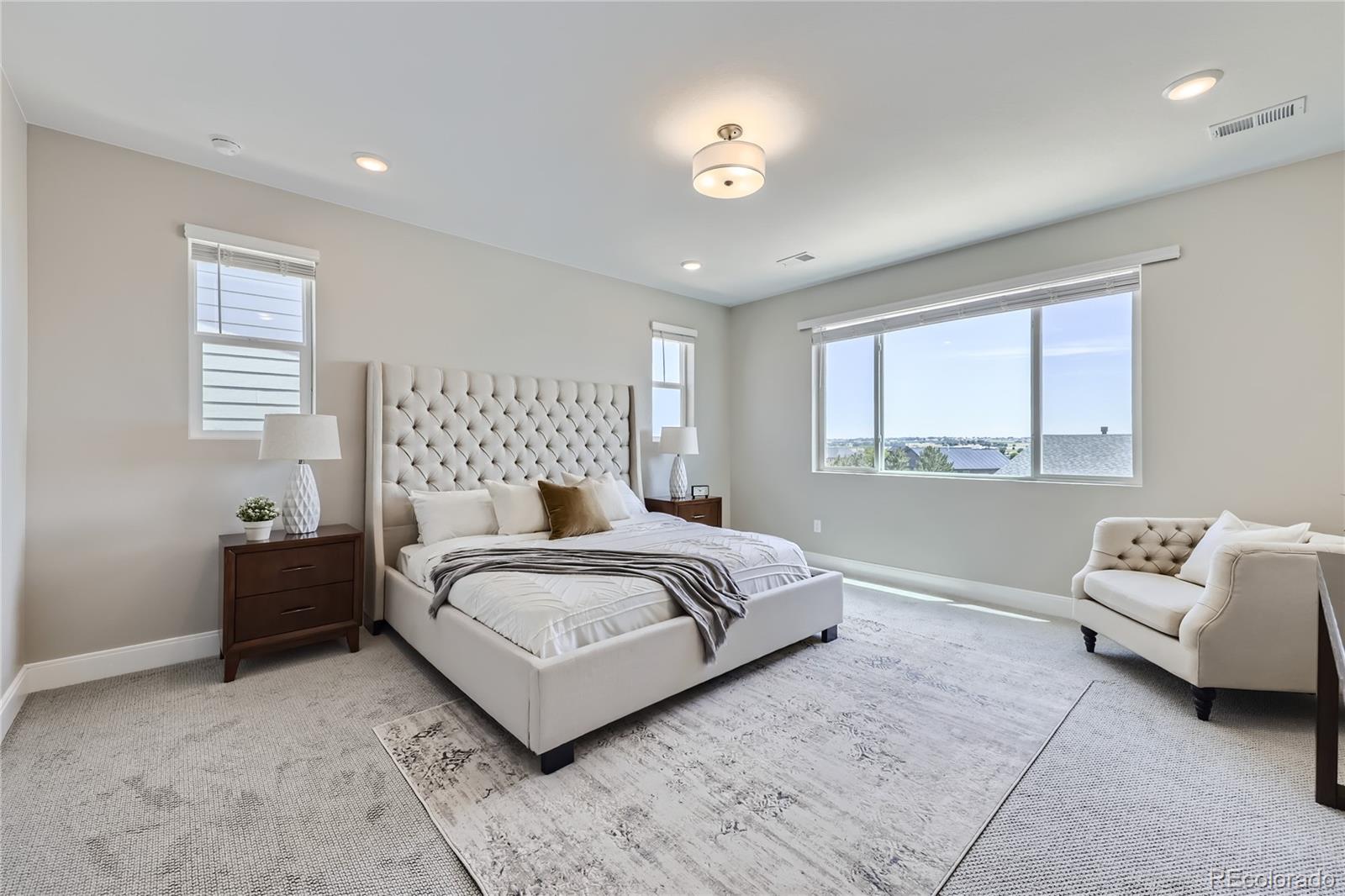 12864 Pinnacle Firestone, CO 80504 - Photo 10 of 29 a bedroom with a bed and a couch