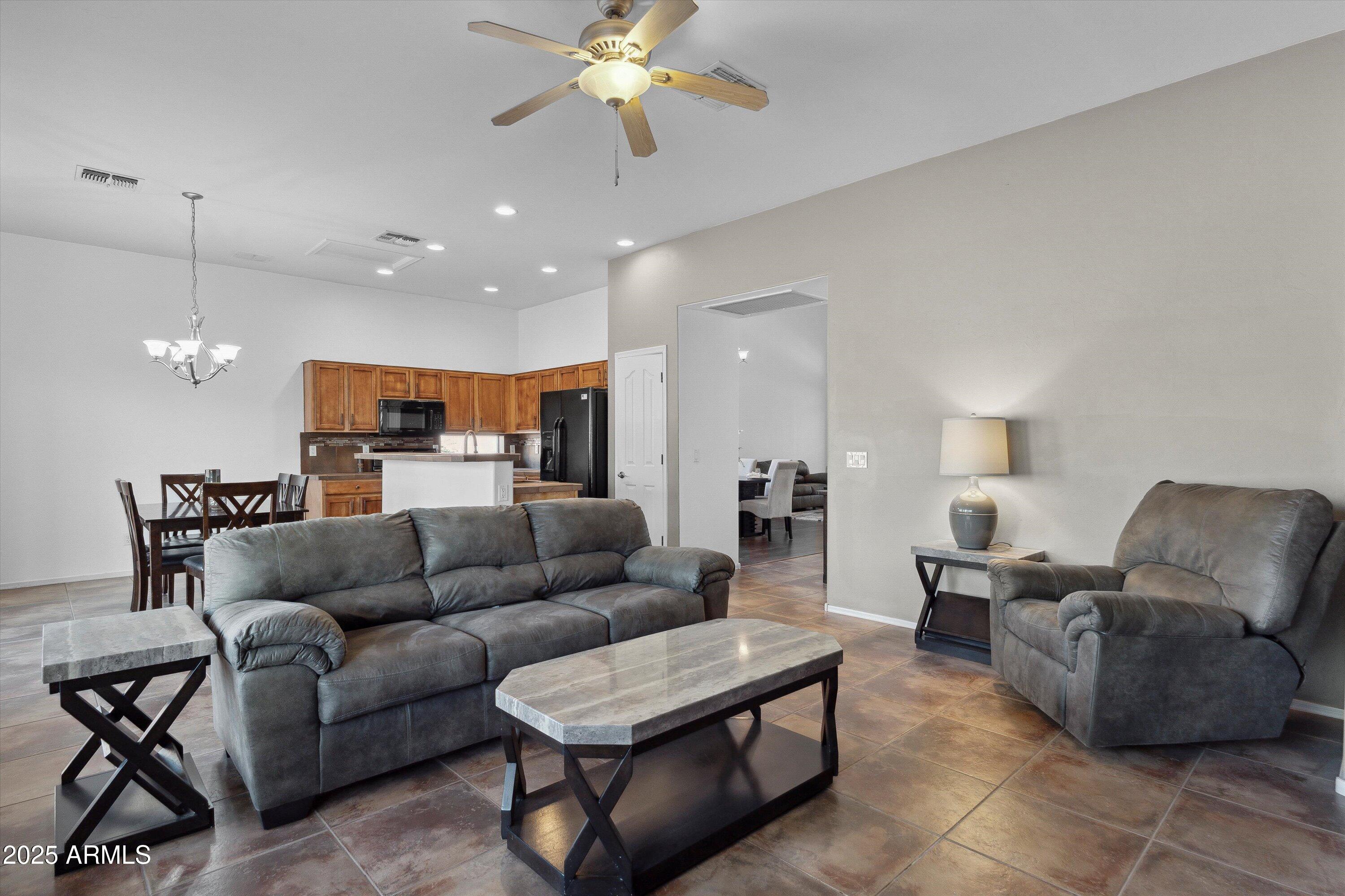 17407 South Purple Mesa Trail Vail, AZ 85641 - Photo 9 of 54 a living room with furniture kitchen view and a chandelier