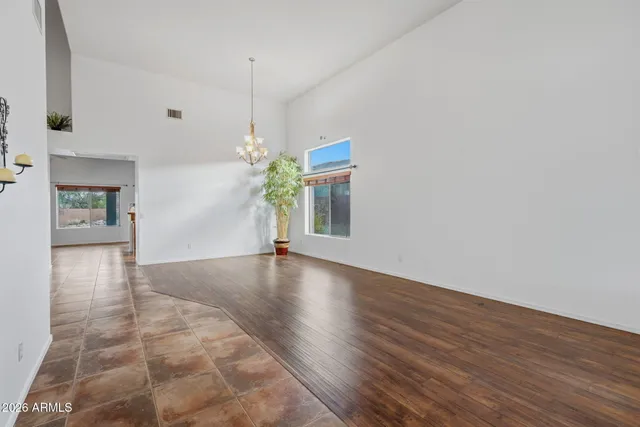 a view of a dining room with furniture and a chandelier
