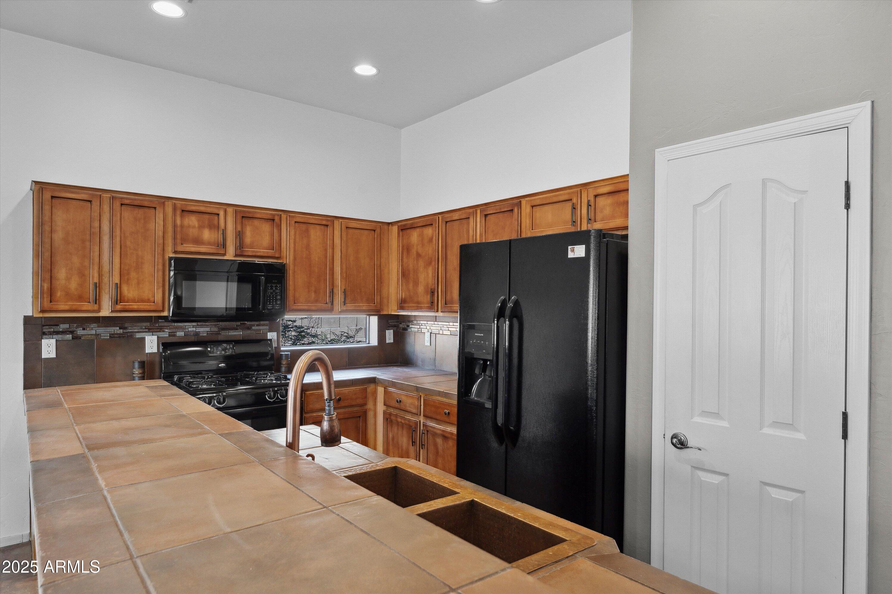 17407 South Purple Mesa Trail Vail, AZ 85641 - Photo 13 of 54 a kitchen with stainless steel appliances granite countertop a refrigerator and a stove top oven