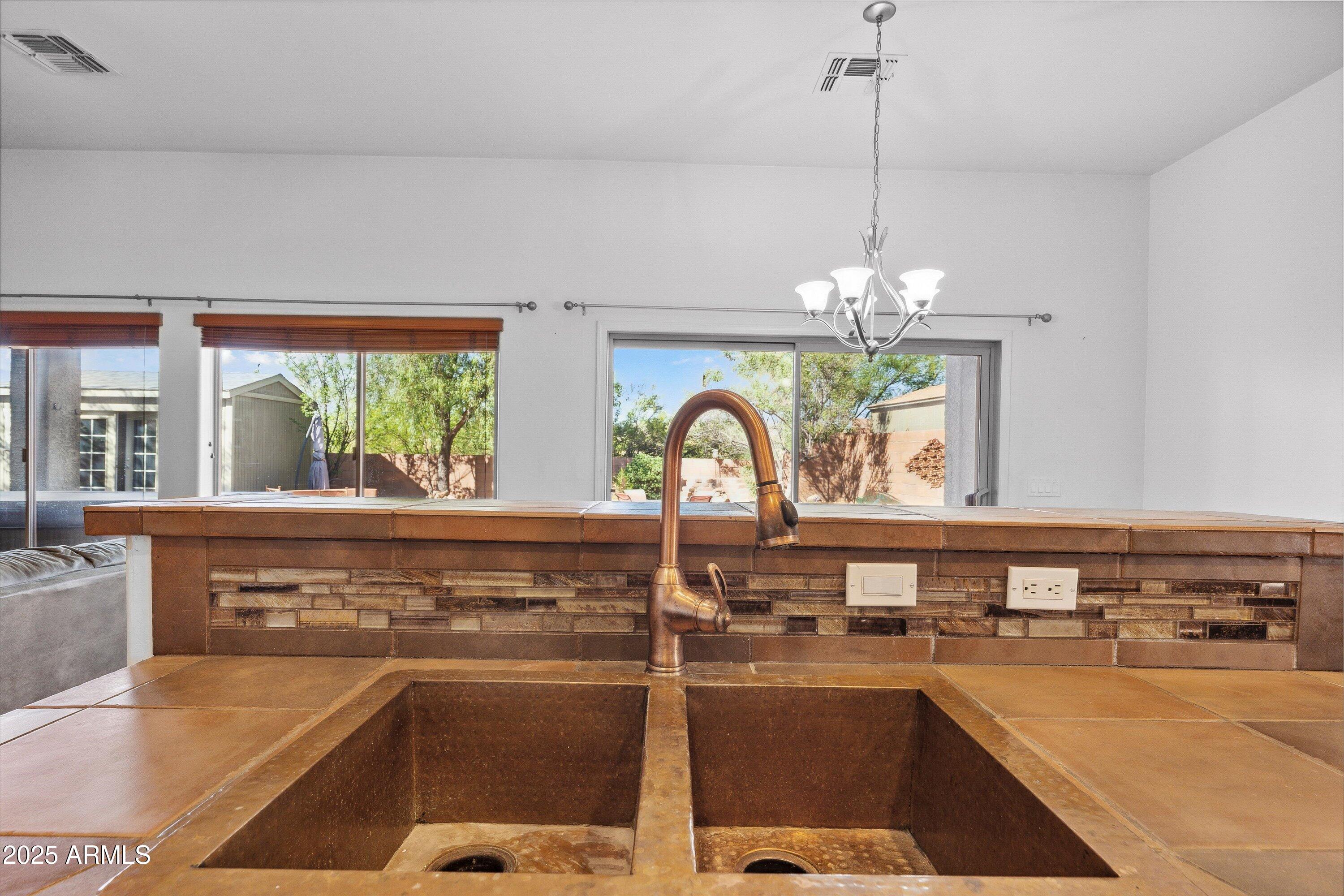 17407 South Purple Mesa Trail Vail, AZ 85641 - Photo 15 of 54 a open kitchen with a sink a counter top space appliances and cabinets