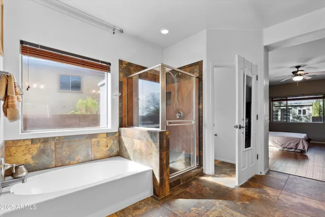 a spacious bathroom with a tub and shower