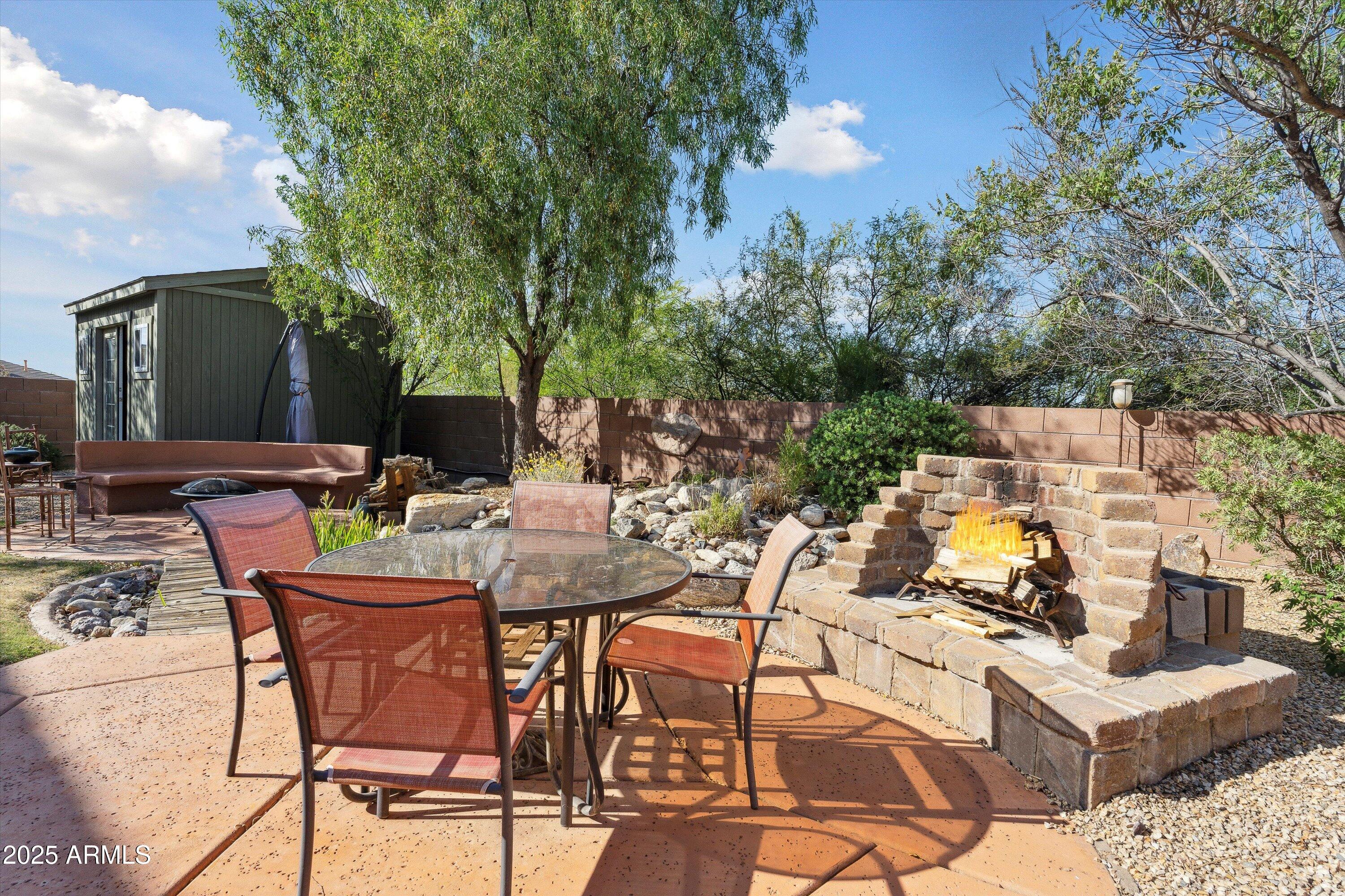 17407 South Purple Mesa Trail Vail, AZ 85641 - Photo 36 of 54 a view of a patio with table and chairs and potted plants with large tree