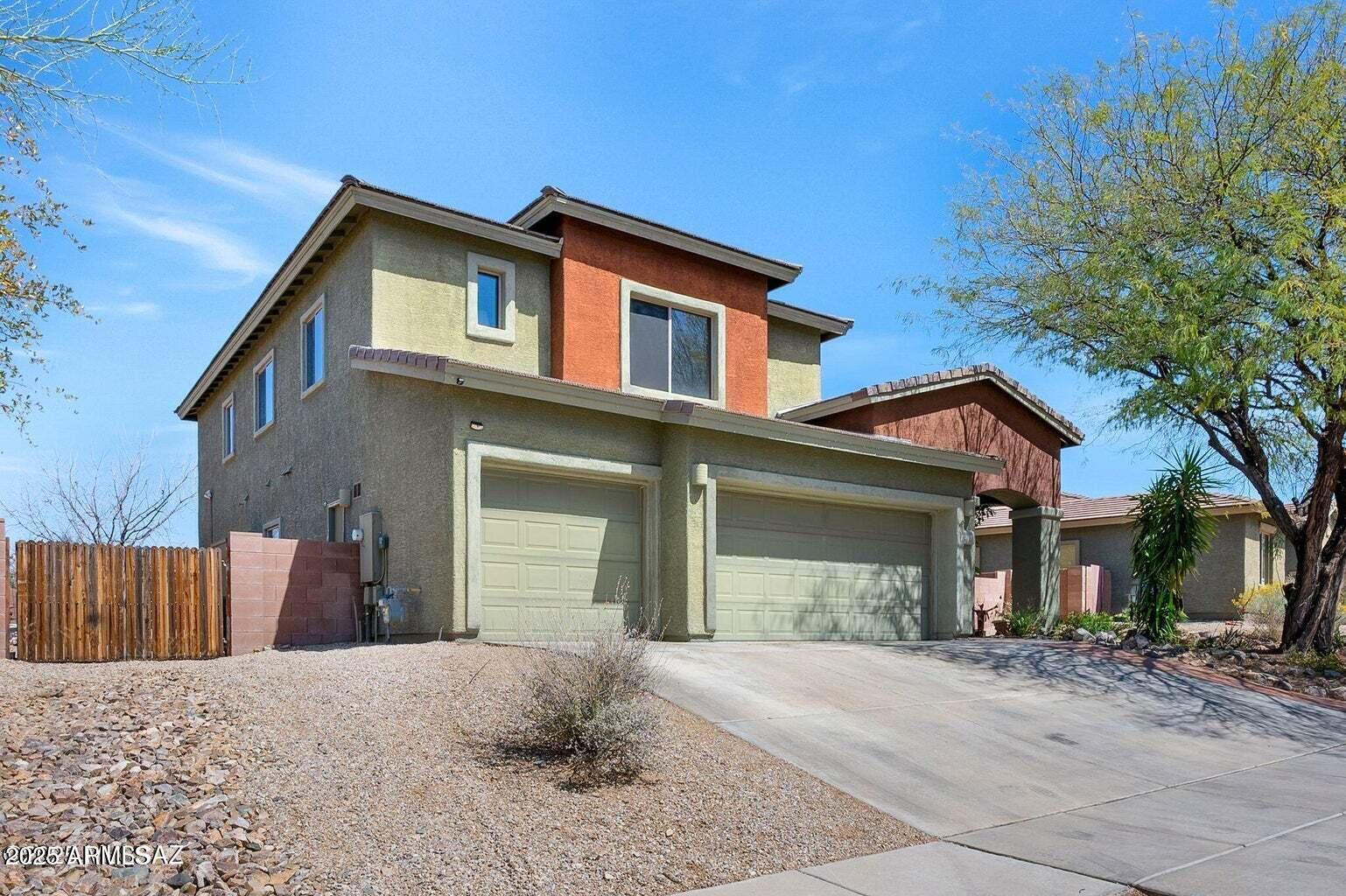 17407 South Purple Mesa Trail Vail, AZ 85641 - Photo 51 of 54 a front view of a house with a yard and garage