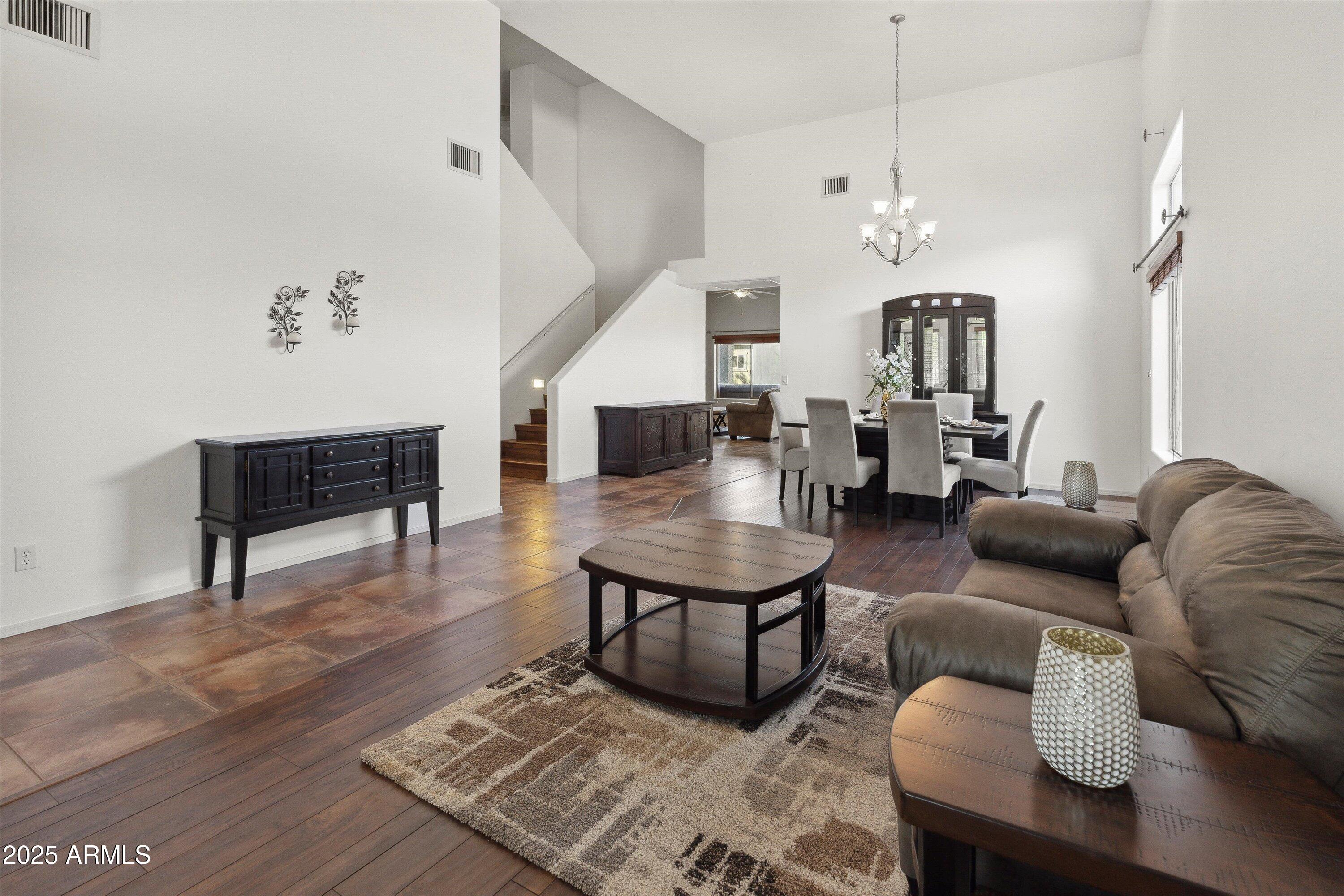 17407 South Purple Mesa Trail Vail, AZ 85641 - Photo 5 of 54 a living room with furniture a rug and a chandelier