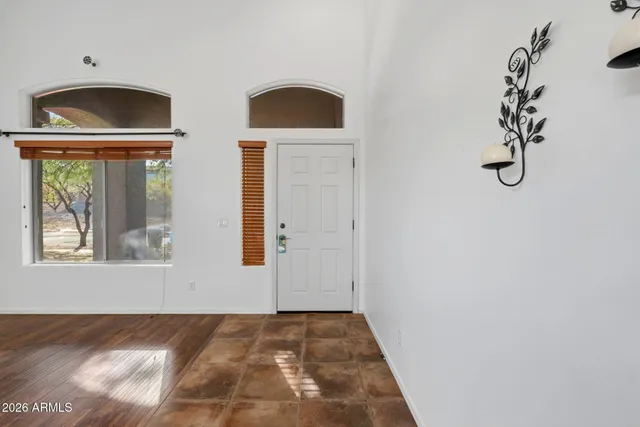 a living room with furniture kitchen view and a chandelier