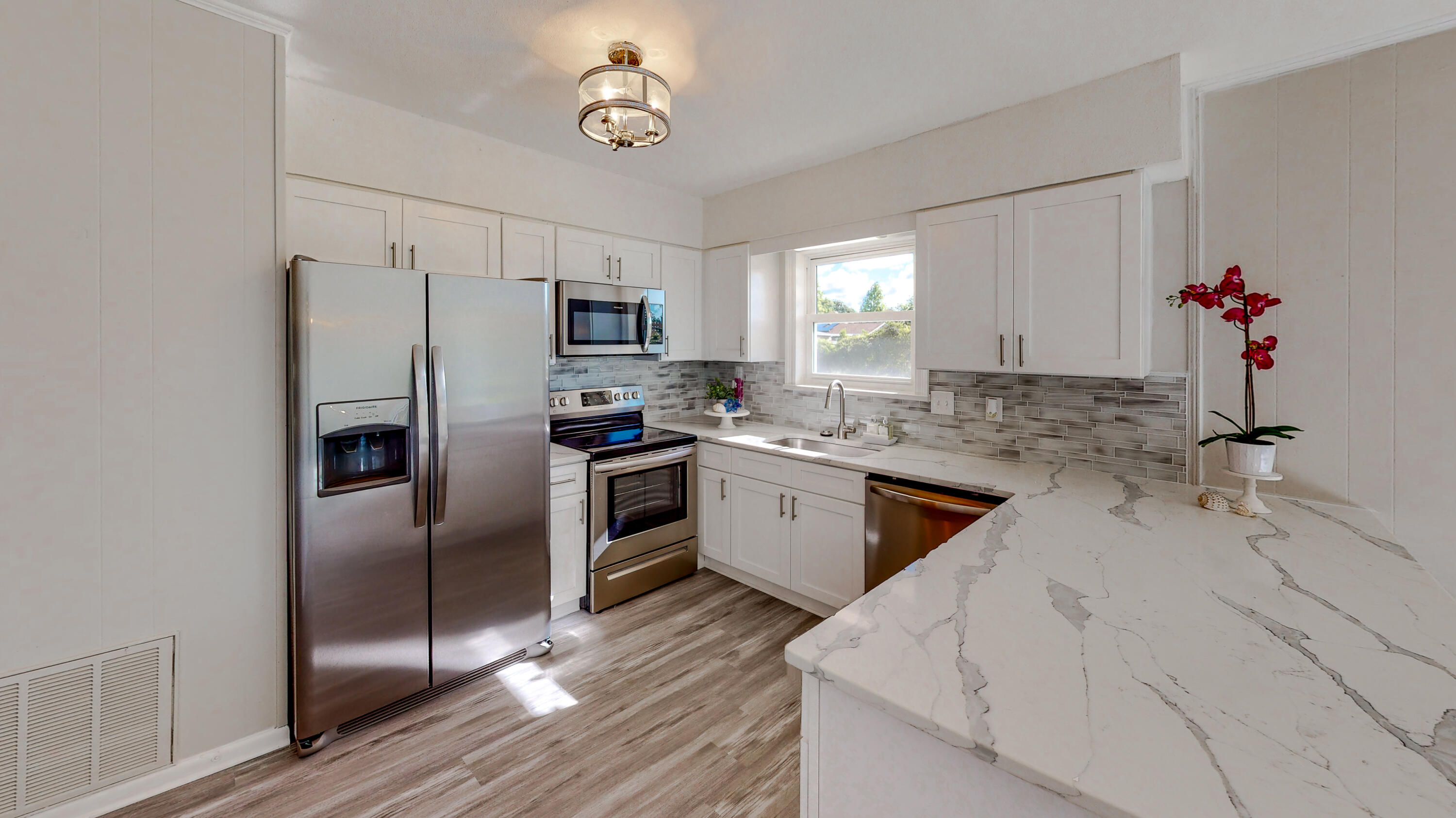 a kitchen with a refrigerator sink and stove